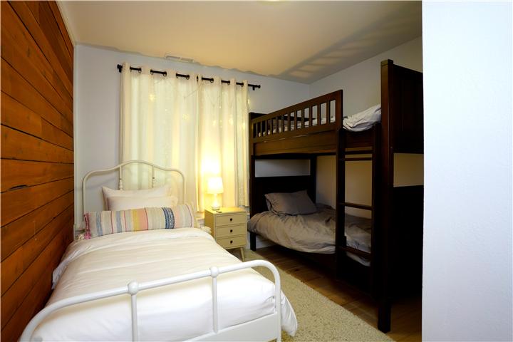 Bedroom with a twin bed and a bunk bed
